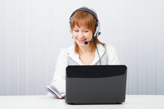 girl with laptop in headphones with a microphone. HotLine