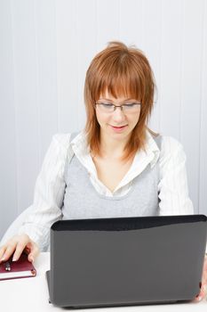 Disheveled girl with laptop in the office. Hard day