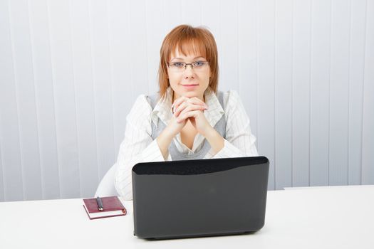 girl in office looking at laptop. Office