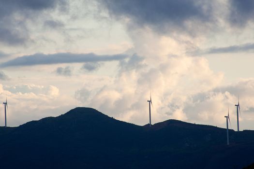 View of Wind turbines in the mountain with clouds