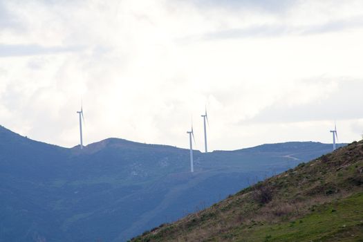 View of Wind turbines in the mountain with clouds