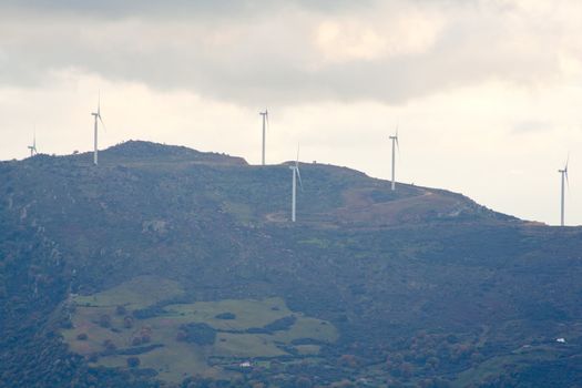 View of Wind turbines in the mountain with clouds