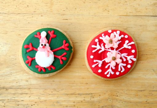 Decorated colorful gingerbreads on wooden background