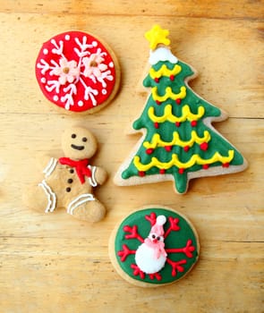 Decorated christmas gingerbreads on wooden background