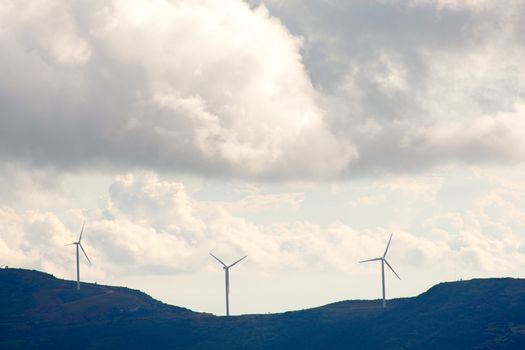 View of Wind turbines in the mountain with clouds
