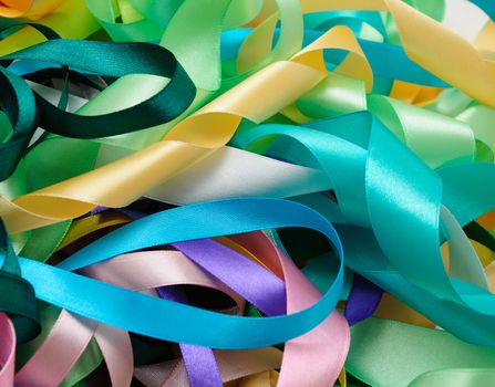 Multi-colored satin ribbons in a chaotic manner closeup


