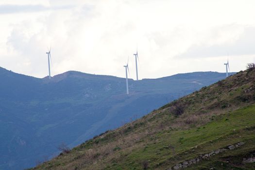 View of Wind turbines in the mountain with clouds