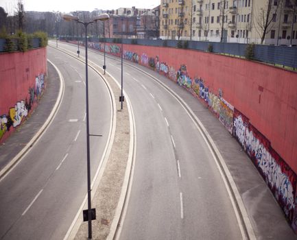 View of a road with graffiti on the wall