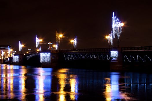 Night horizontal view of Palace Bridge across Neva river. St Petersburg, Russia