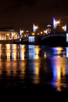 Night vertical view of Palace Bridge across Neva river. St Petersburg, Russia