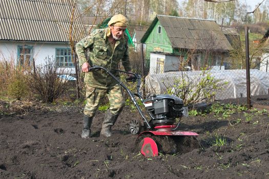 The man cultivates the ground on the site