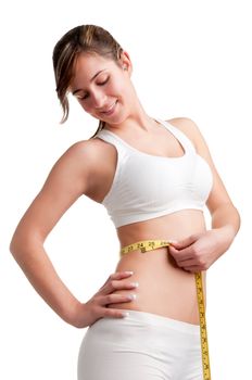 Woman measuring her waist with a yellow measuring tape, isolated in white