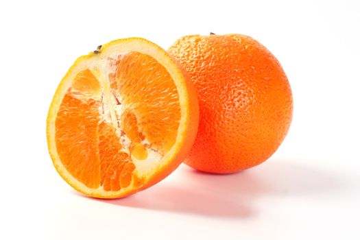 Two perfectly fresh oranges isolated on white