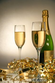 Fluted champagne glasses with champagne bottle ready  for celebrations
