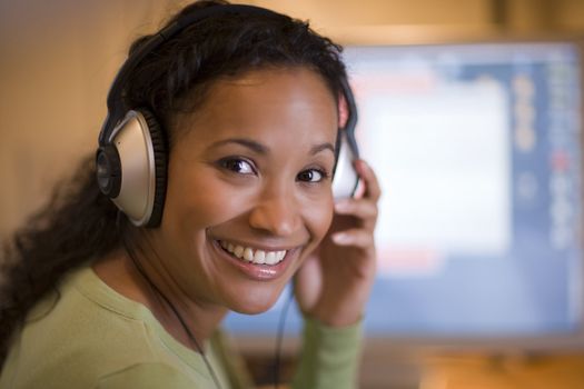 Pretty smiling African American woman with headphones