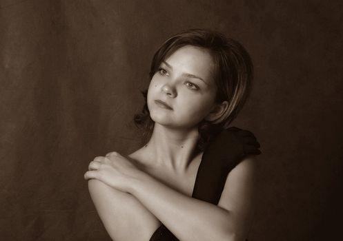 Portrait of the beautiful girl on a dark background