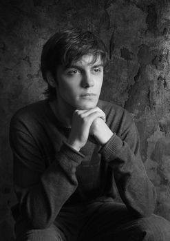 Portrait sad young men, a chin on his hands. b/w