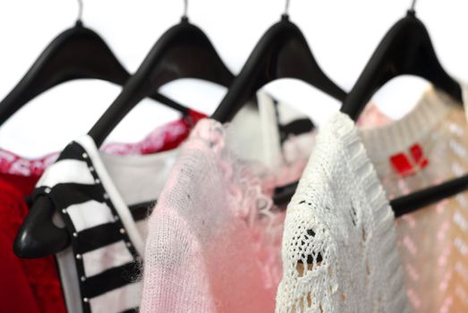 Women's clothing on a rack, white background