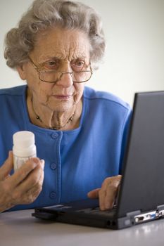 Senior woman researching prescription  on-line