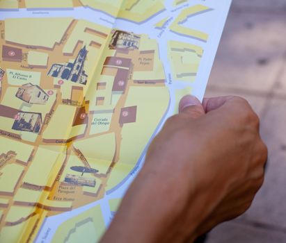 Woman reading a brochure, close up of the hands