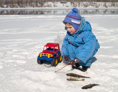 The boy, the child on winter fishing