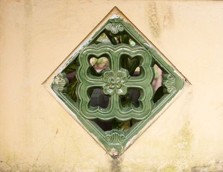 an ornamental window in old wall background