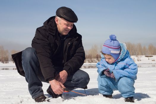 The boy, the child with the father on on winter fishing