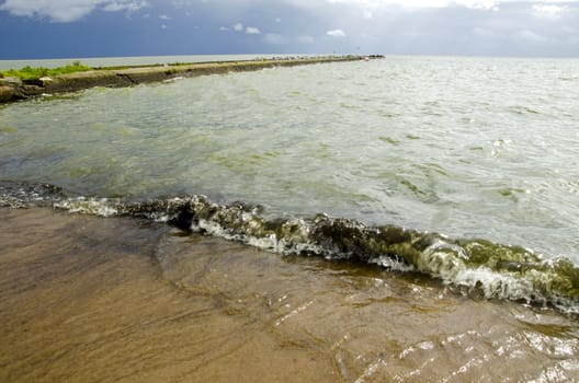 summer sea landscape with pier and wave