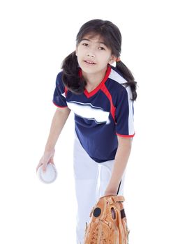 Little biracial asian girl in softball team uniform ready to throw a pitch