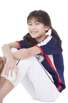 Biracial asian girl holding softball and glove while sitting, isolated