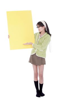 Cute biracial asian girl in green sweater and glasses gesturing to a blank yellow sign, isolated