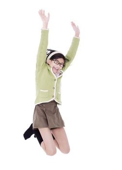 Biracial asian girl in green sweater jumping for joy