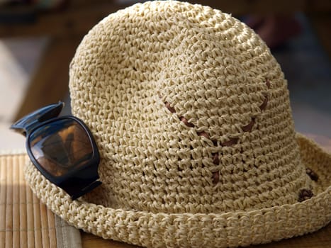 A hat and sunglasses - beach attributes