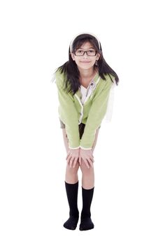 Cute biracial asian girl in green sweater and glasses bending forward, hand on knees