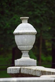 Vase on a plinth. Garden art. Decorative hard landscape.