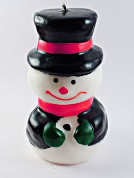 Toy snowman with black jacket isolated on white background