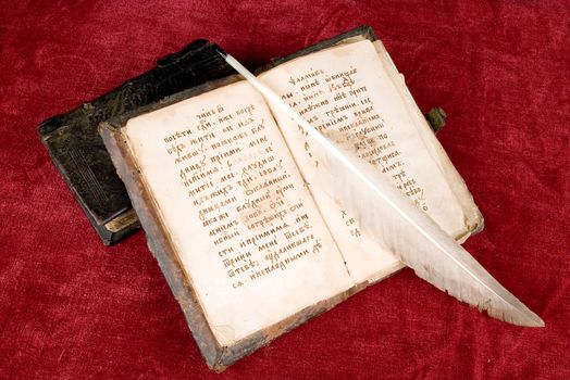 old book with a quill pen