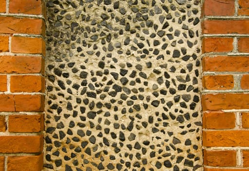 Wall decorated with small pebble stones. Architecture background details.