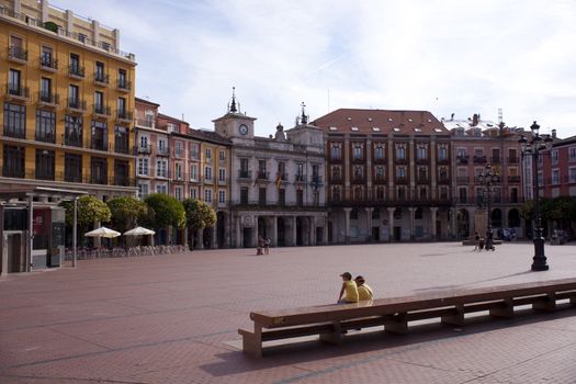People sitting in the Burgos square