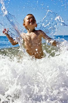 Young child playing in the sea