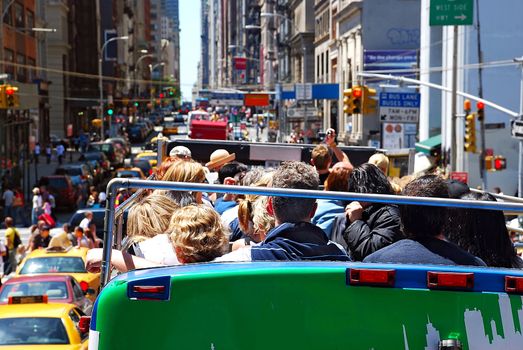 city sight bus on crowded  street with tourists