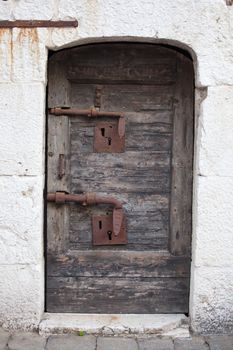 Old wooden door with rusty bolt