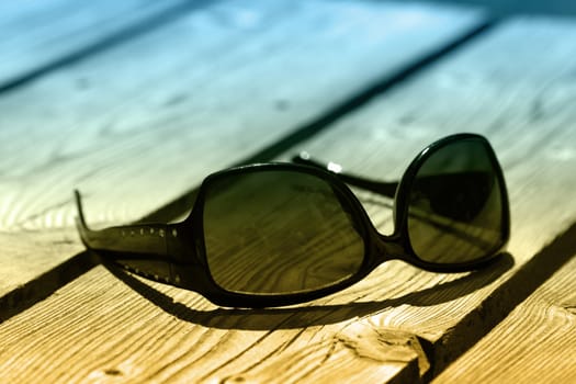 sunglasses on a wood table