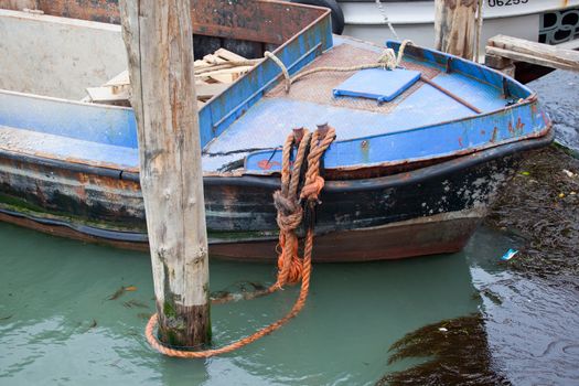 Old boat about to sink in Venice