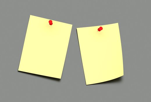 two yellow post-it on a grey background