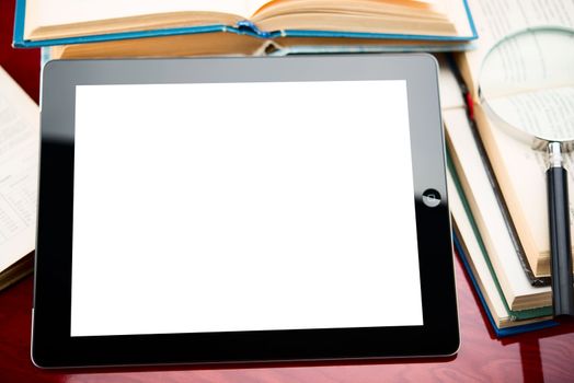 tablet pc with blank screen on a book background