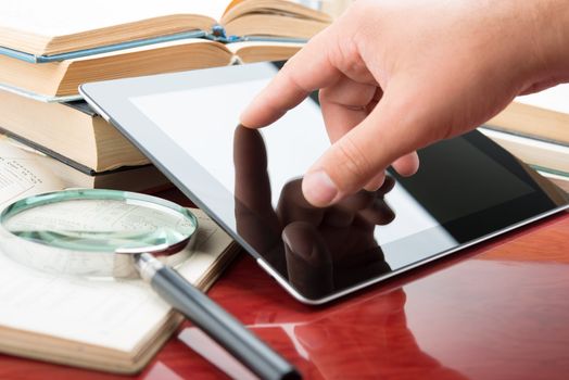 Hand touching a touchscreen of tablet pc