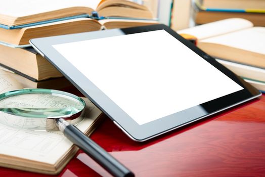 tablet pc with blank screen on a book background