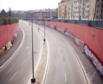 View of a road with graffiti on the wall