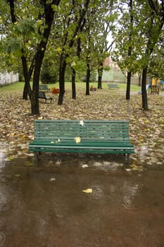 Bench in autumn under rain